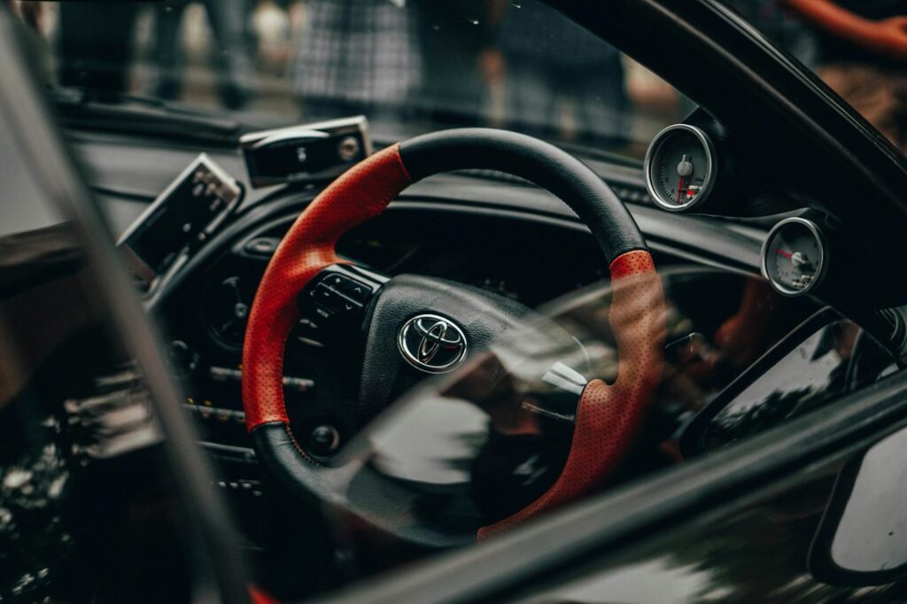 Black and Red Toyota Car Steering Wheel