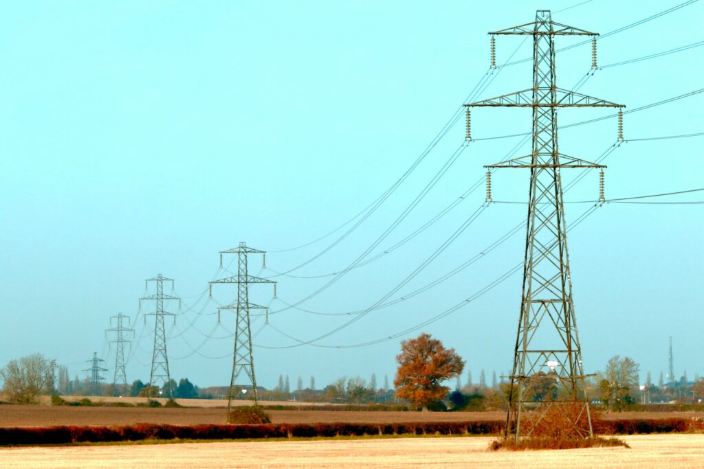 brown and black electric towers under white sky during daytime