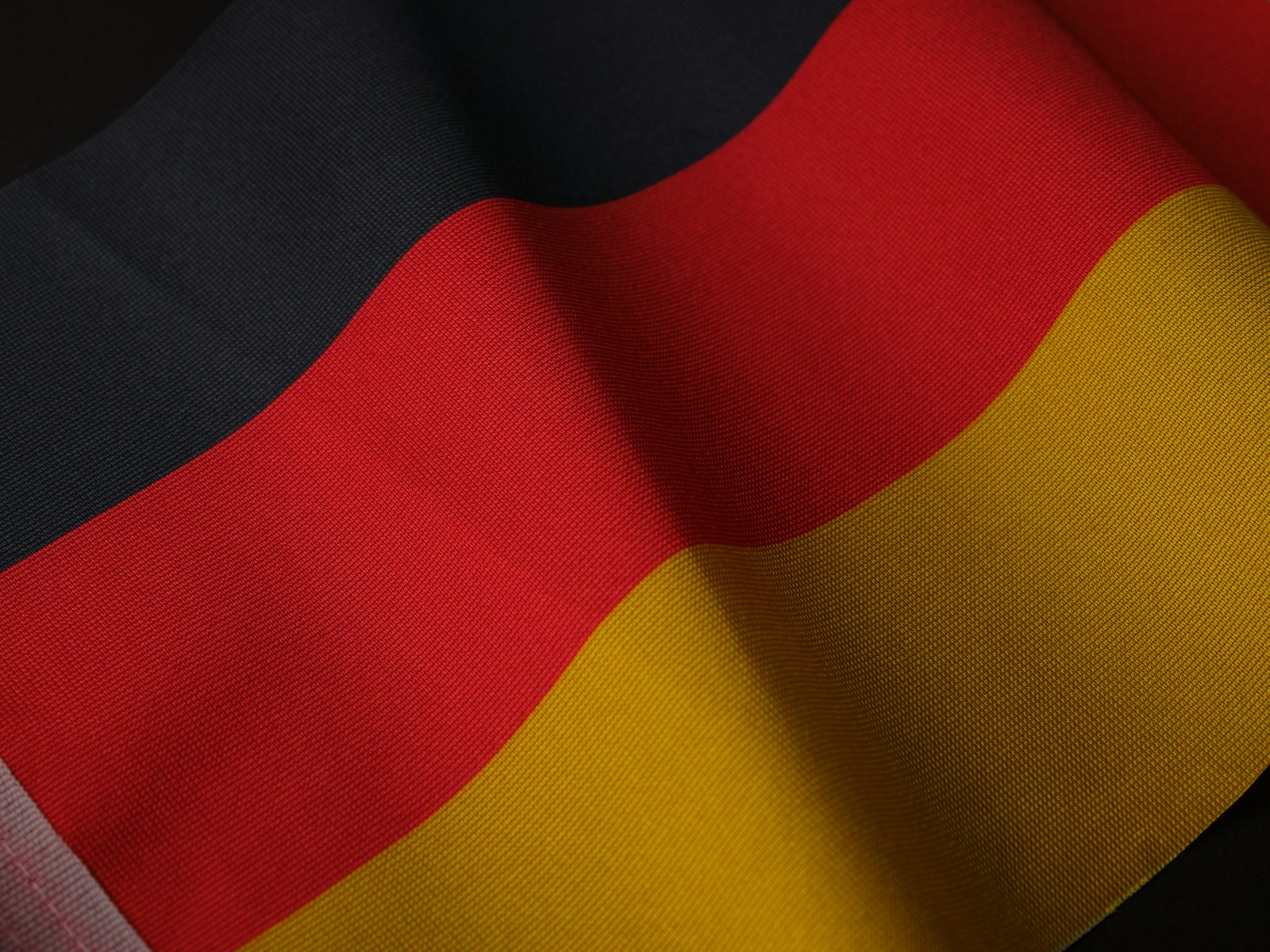 a close up of a red, yellow and black flag