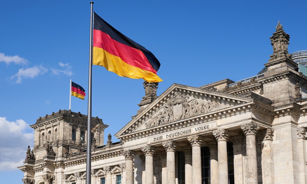 a german flag flying in front of a building