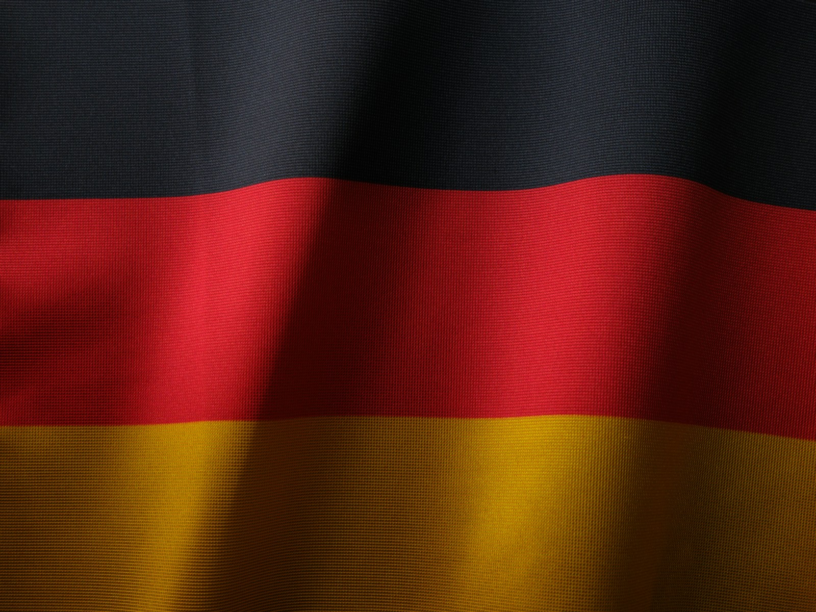 the flag of germany is waving in the wind