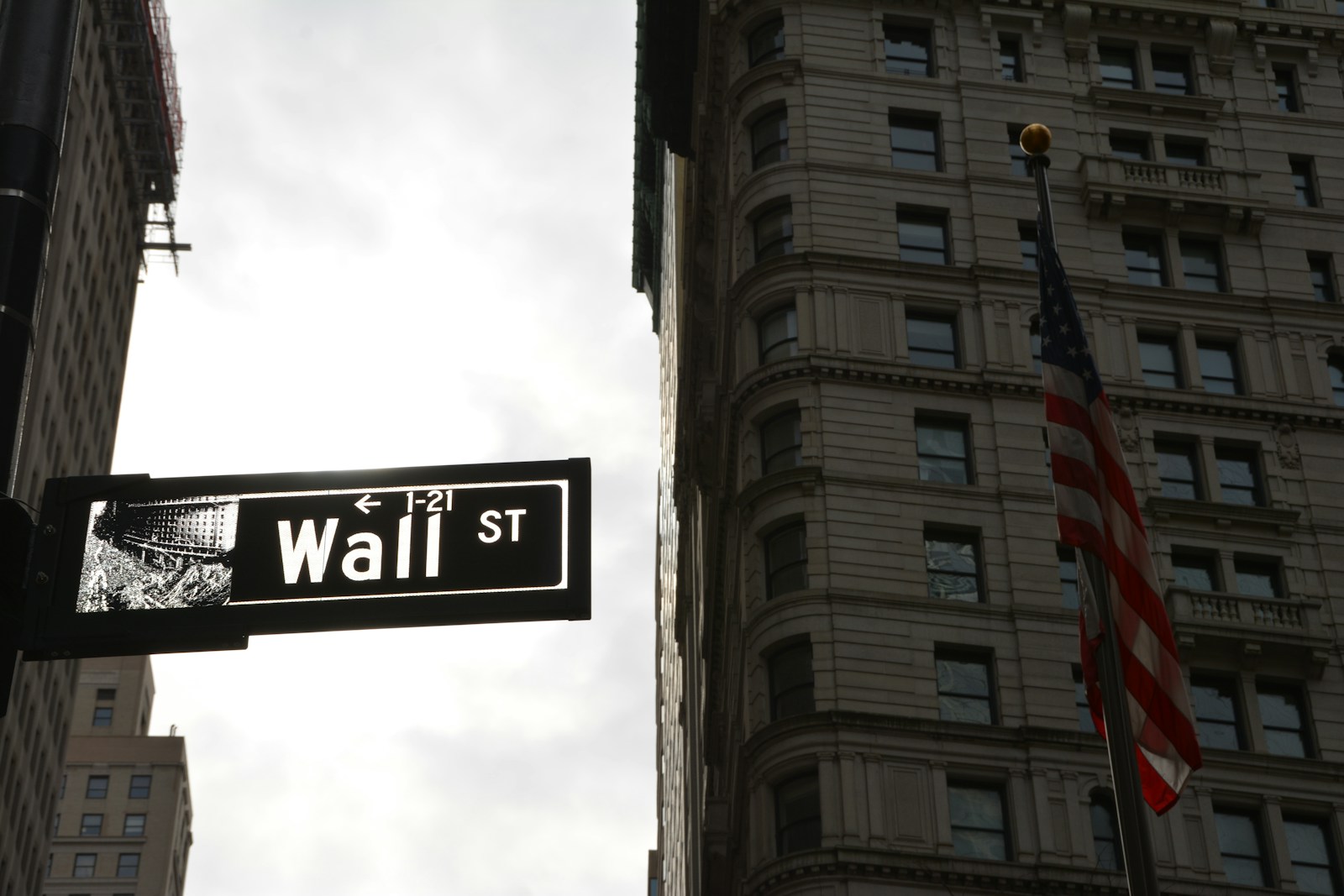 a street sign in front of a tall building