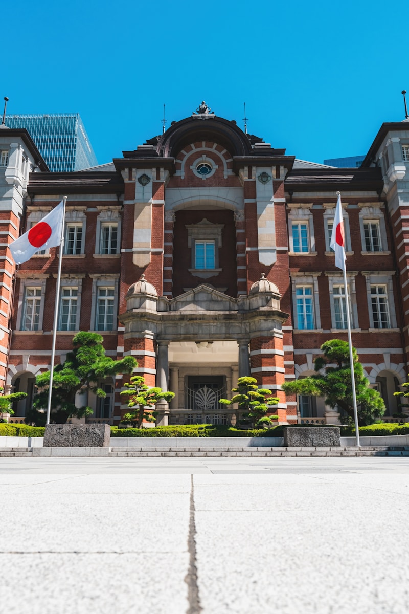 a large building with flags flying in front of it