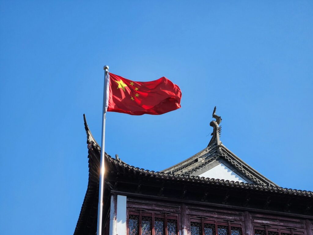 A chinese flag flying on top of a building