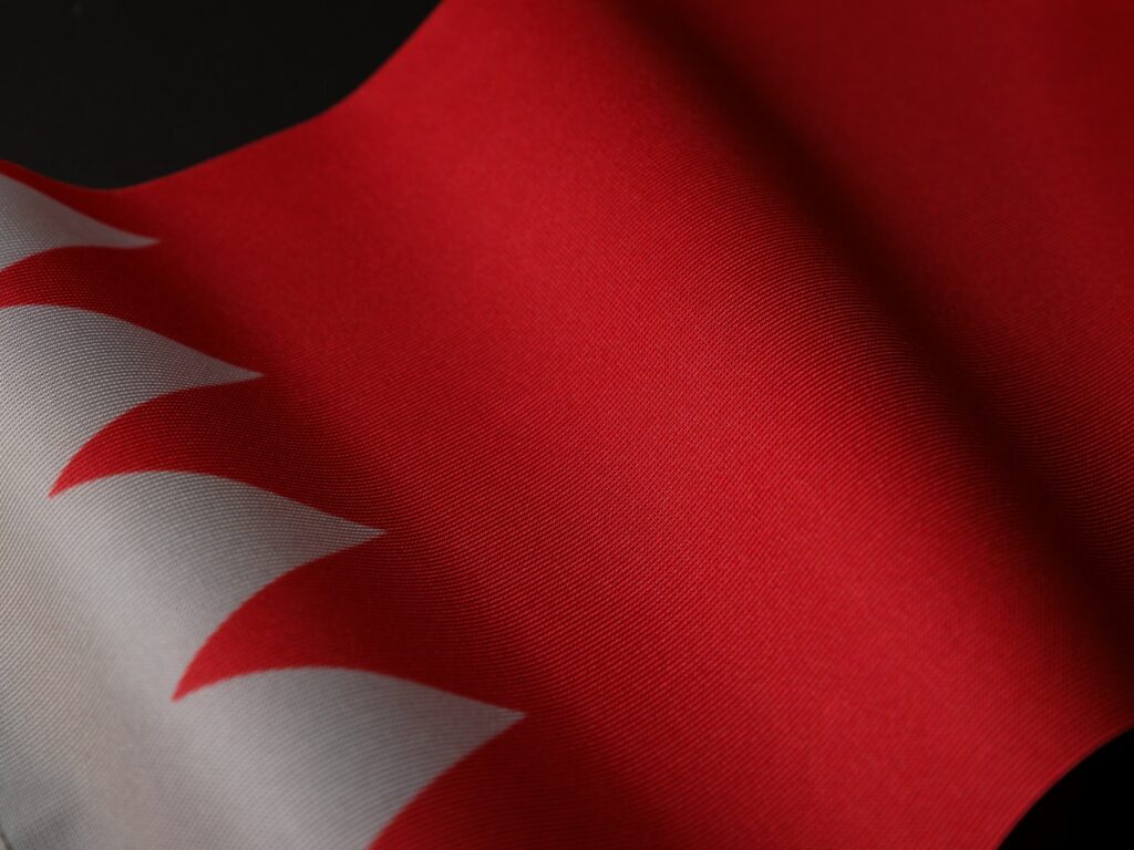 a close up of a red and white flag