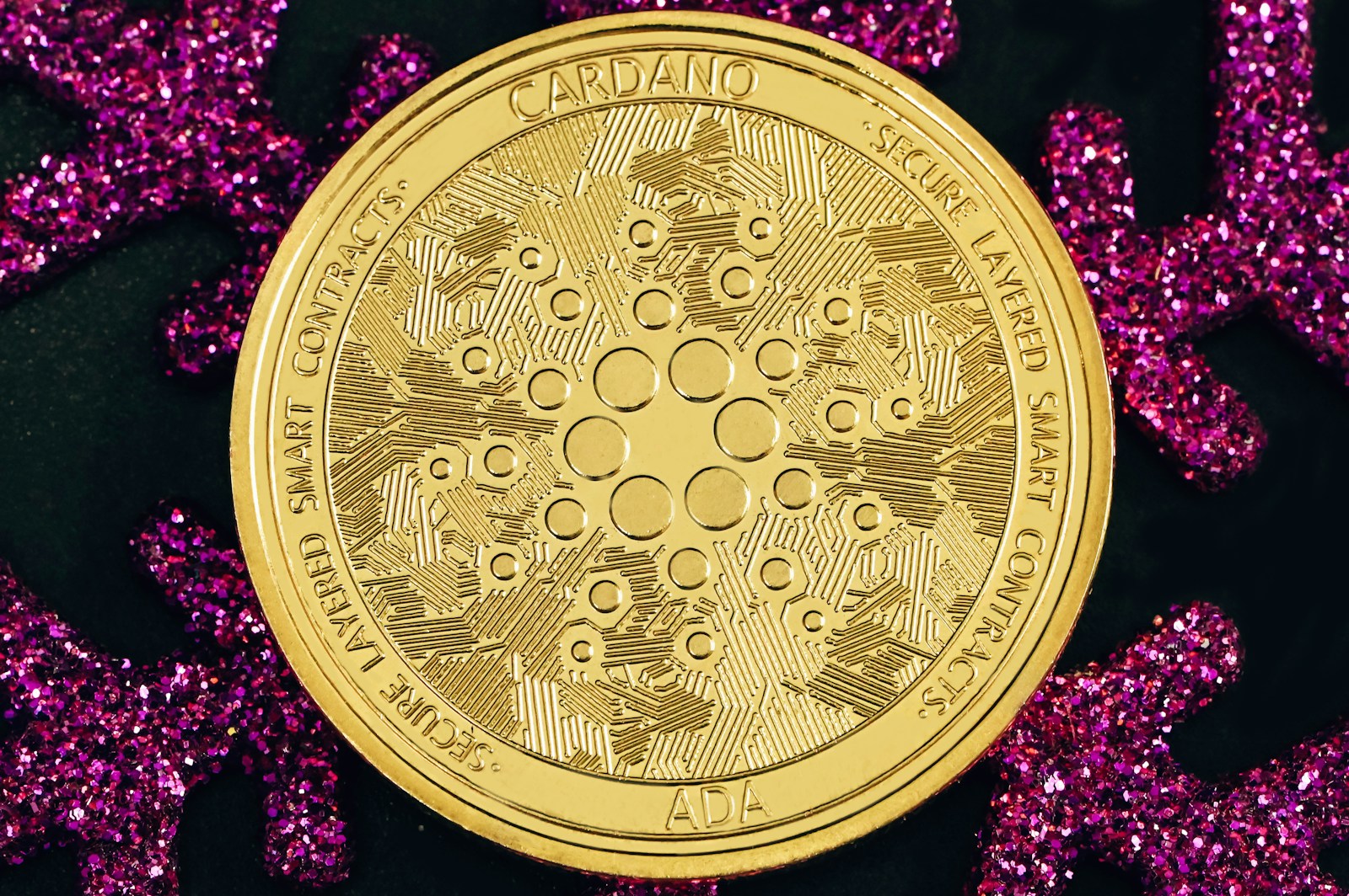 a gold coin sitting on top of purple glitter