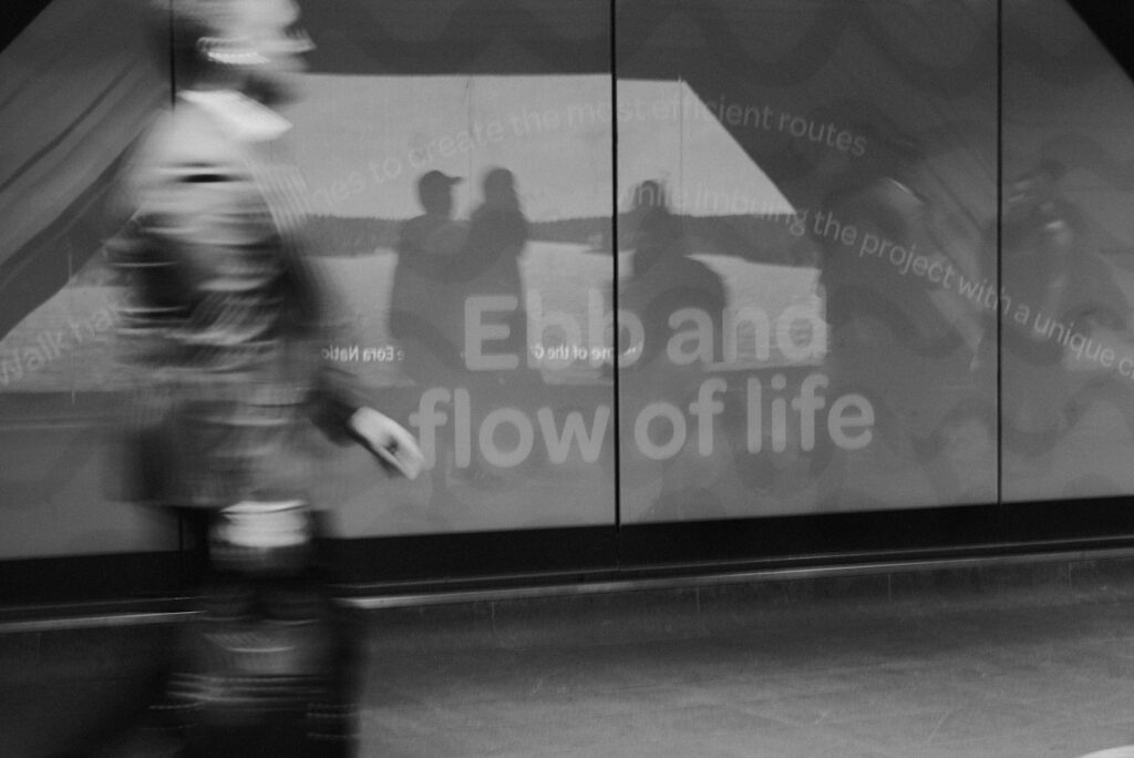 A blurry photo of a person walking past a building