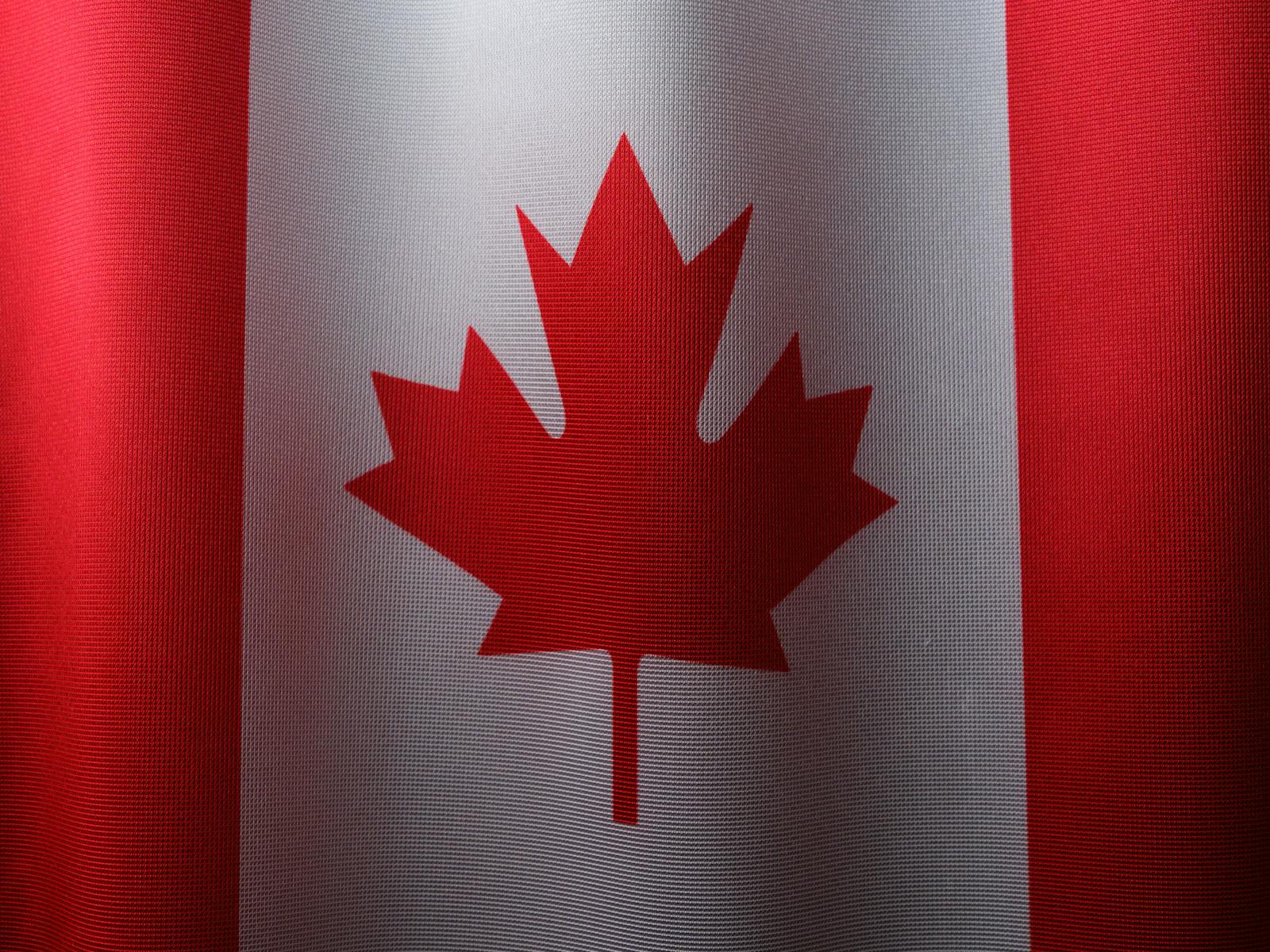 Close-up view of the Canadian flag with its iconic red maple leaf.