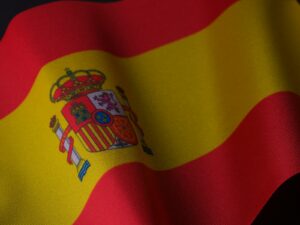 the flag of spain is waving in the wind