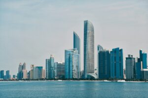a city skyline with a body of water in the foreground