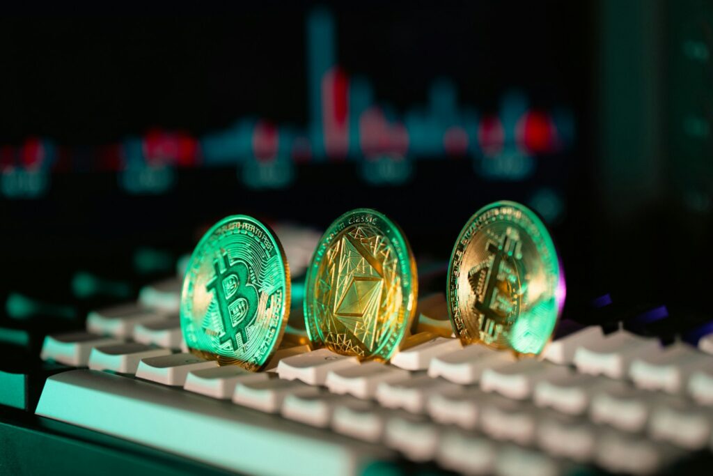 Cryptocurrency coins sit on a keyboard.