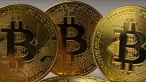 a pile of gold bitcoins sitting on top of each other