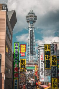 Tsutenkaku tower surrounded by vibrant japanese signs