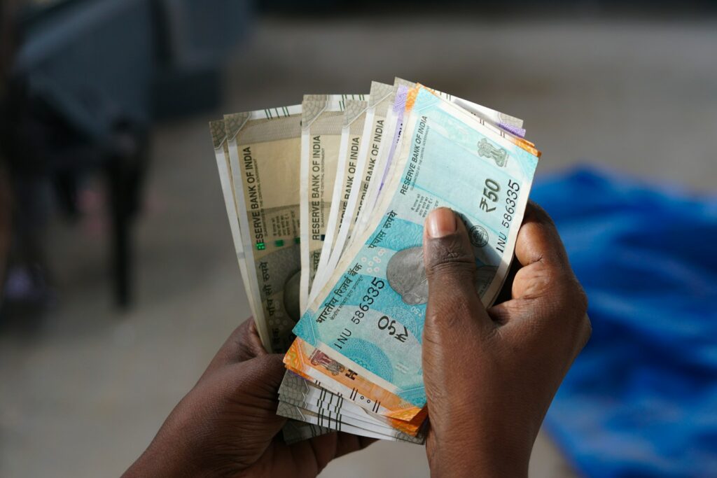 A person holding a bunch of money in their hand