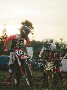 A man riding a dirt bike on top of a field