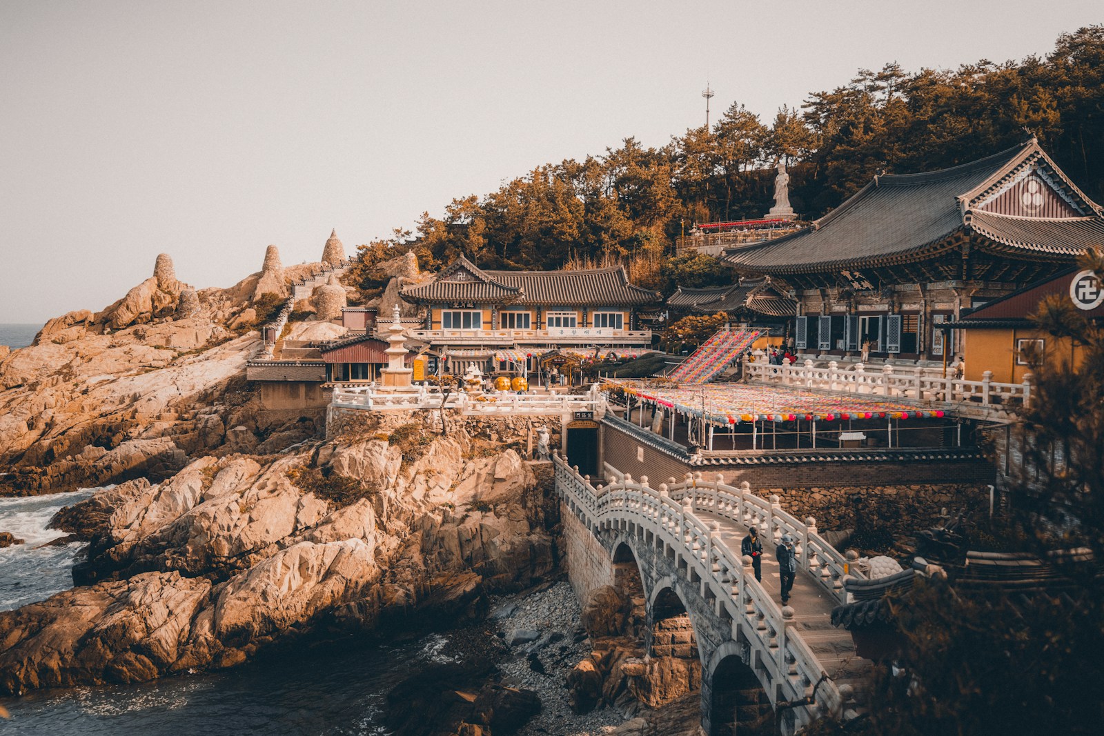 A bridge over a body of water next to a cliff