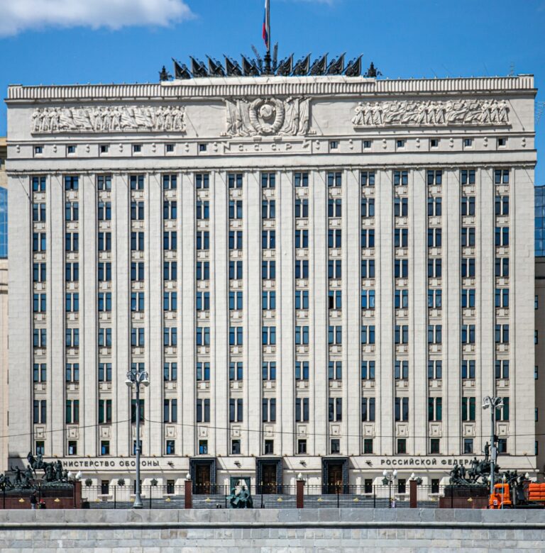 A large white building with a flag on top of it