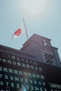 Japanese flag flies above a scoreboard