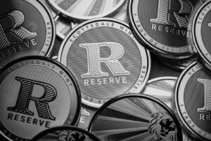 a pile of silver and black coins