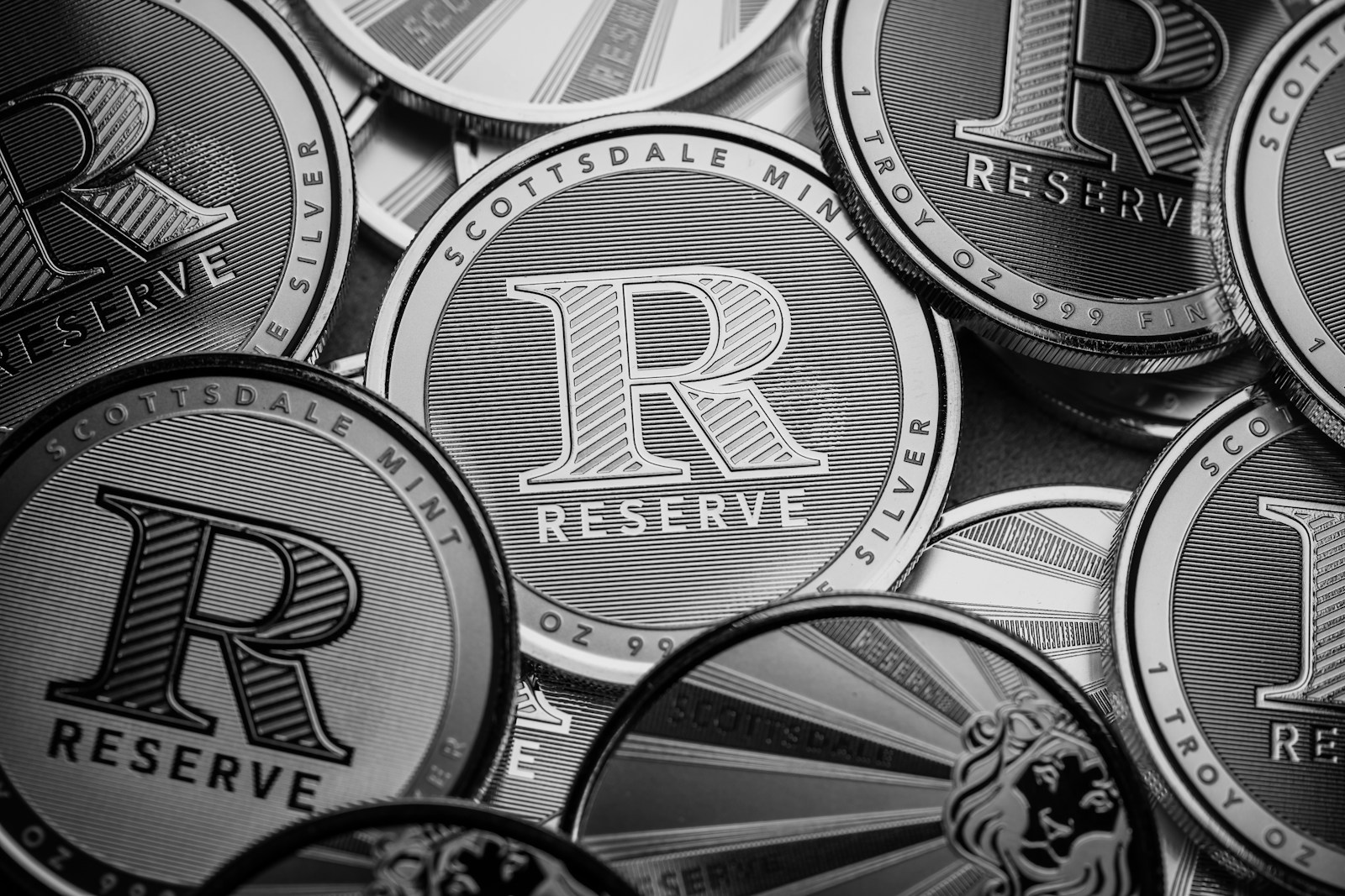a pile of silver and black coins