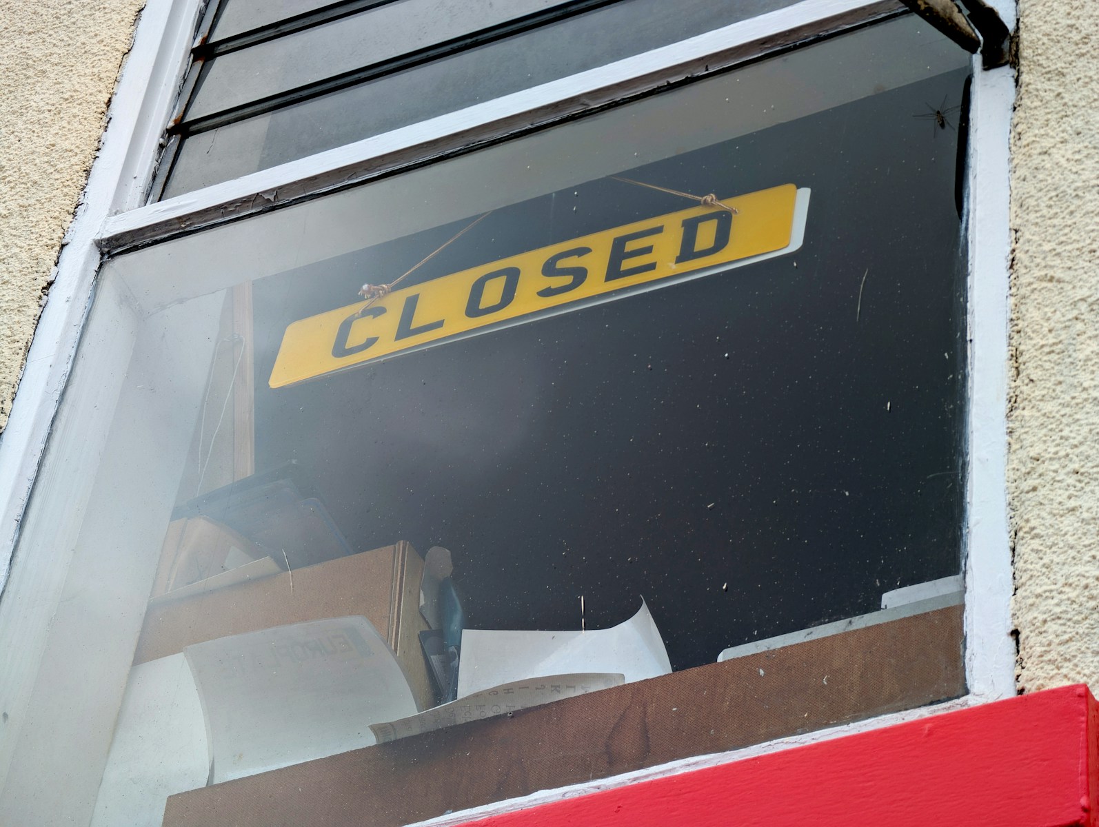 A yellow sign reads closed in a window.