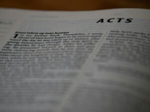 A close up of an open book with the words acts on it