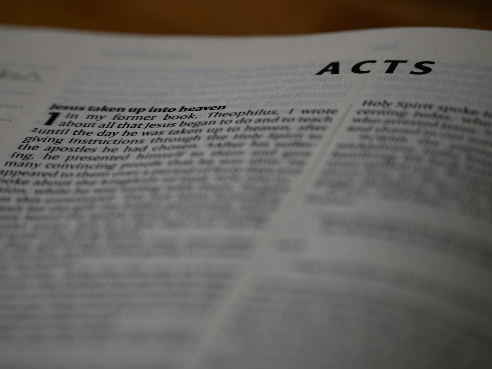 A close up of an open book with the words acts on it
