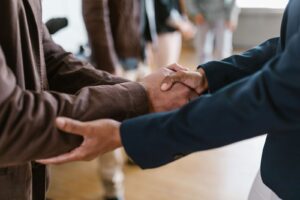 Close-up of two businesspeople shaking hands, symbolizing agreement and partnership.