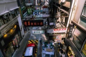 A vibrant view of a busy Hong Kong street market with colorful signage and bustling activity.