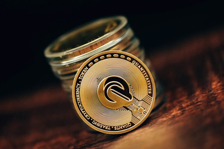 a stack of coins sitting on top of a wooden table