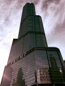 A striking architectural shot of Trump Tower in Chicago against a cloudy sky, showcasing its modern design.
