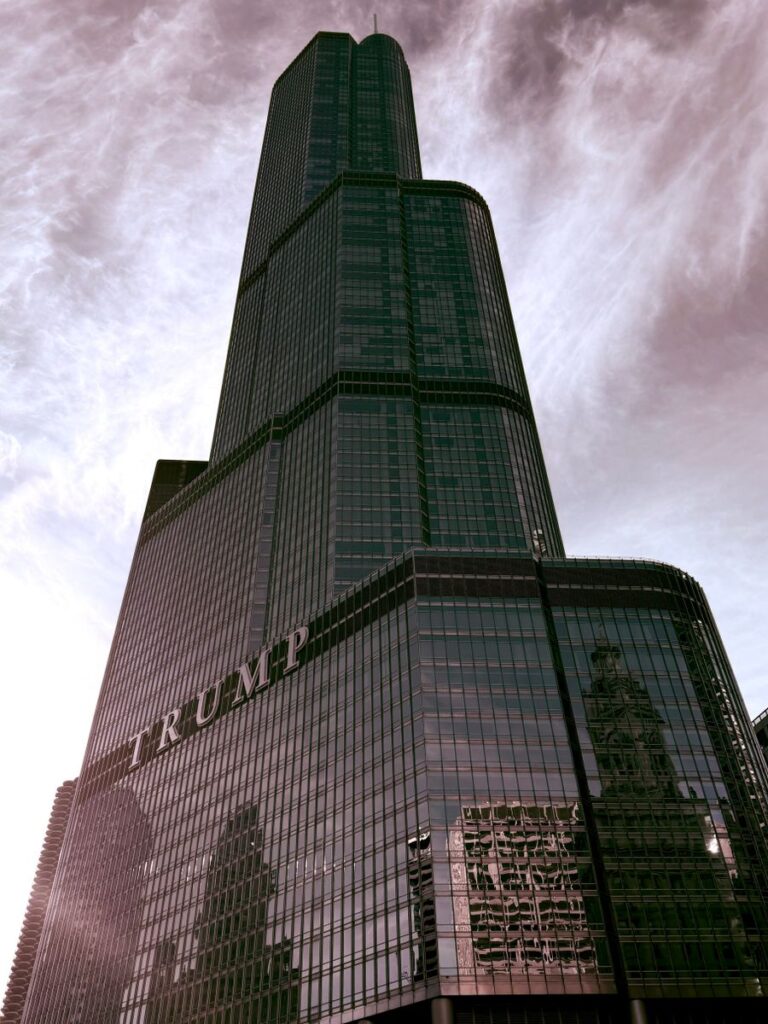 A striking architectural shot of Trump Tower in Chicago against a cloudy sky, showcasing its modern design.