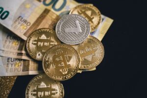 Close-up of bitcoins and euro banknotes, representing modern finance and digital currency exchange.