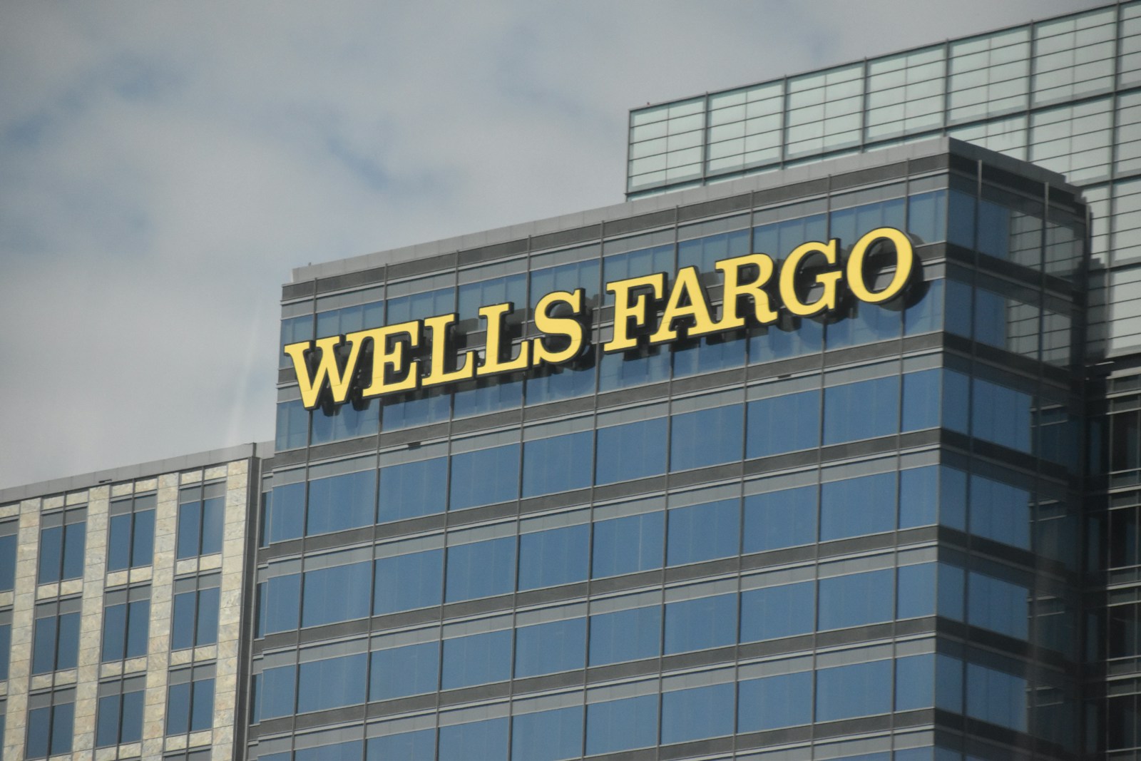 A tall building with a wells fargo sign on top