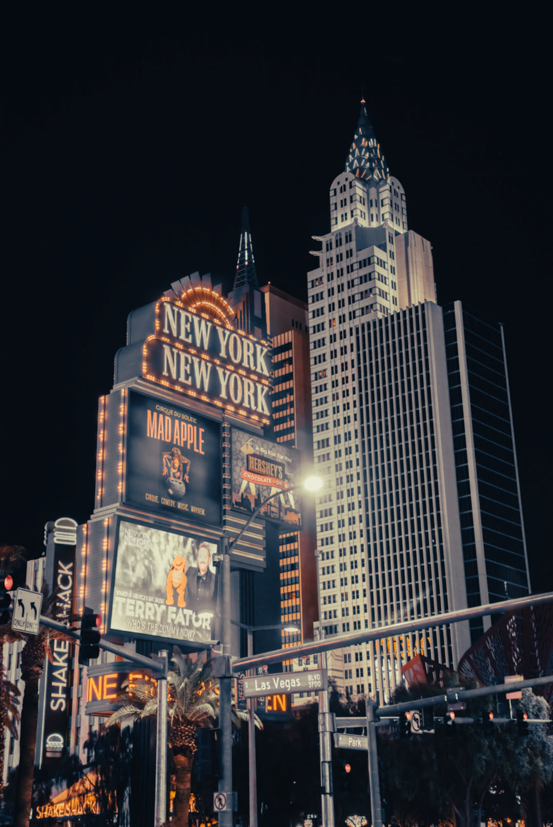 Night view of the iconic New York-New York Hotel in Las Vegas with brilliant lights and modern architecture.