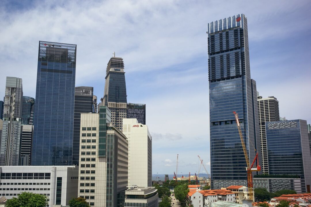 Vibrant cityscape featuring tall skyscrapers under a bright blue sky.