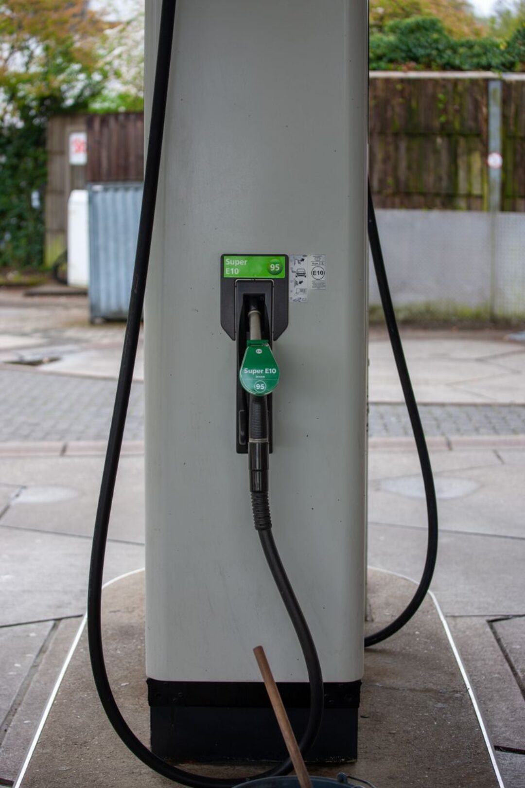 E10 green fuel pump nozzle at a deserted gas station in Bergisch Gladbach, Germany.