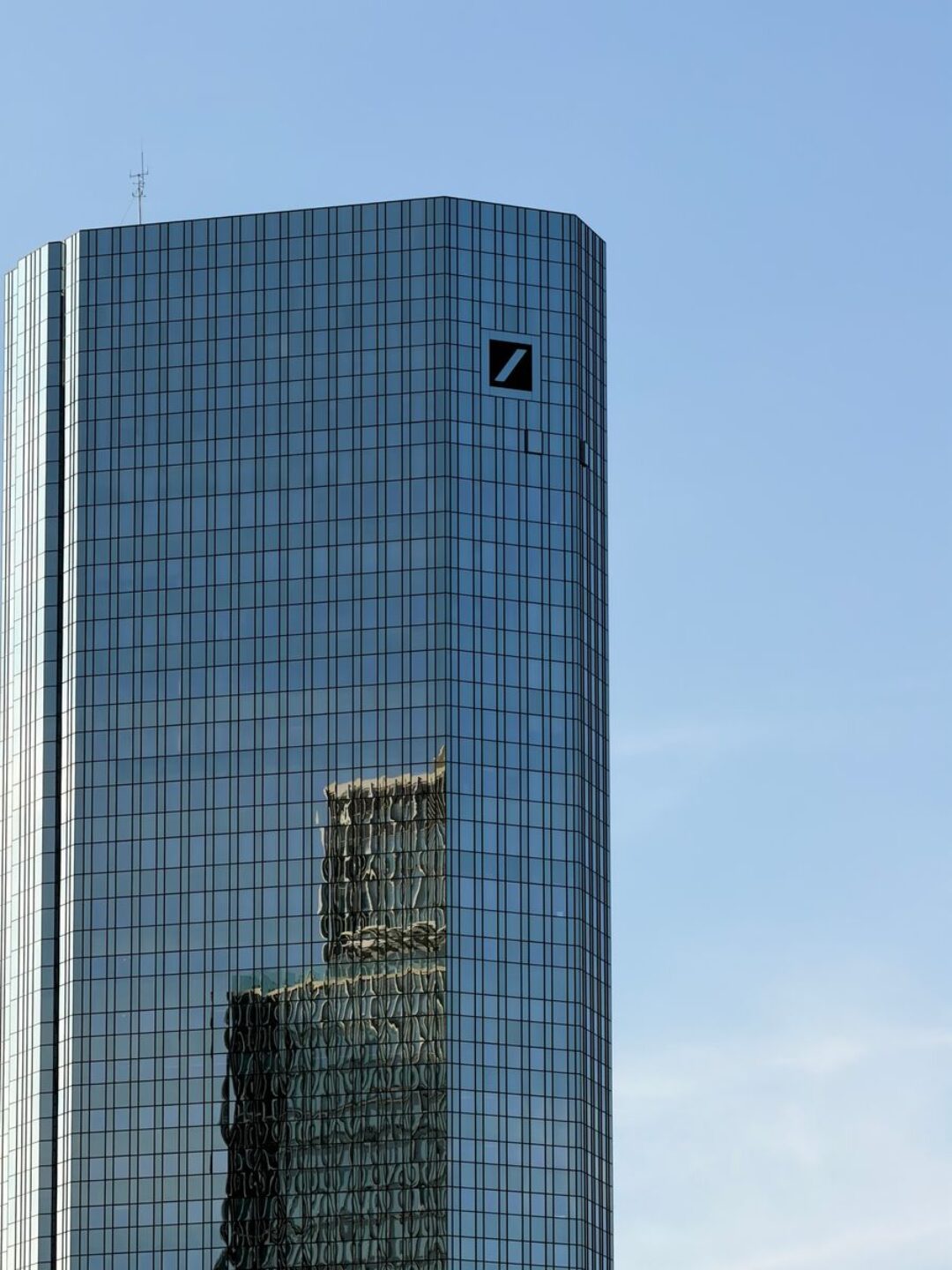 A towering skyscraper with reflective glass façade showcasing urban modern architecture in Frankfurt.