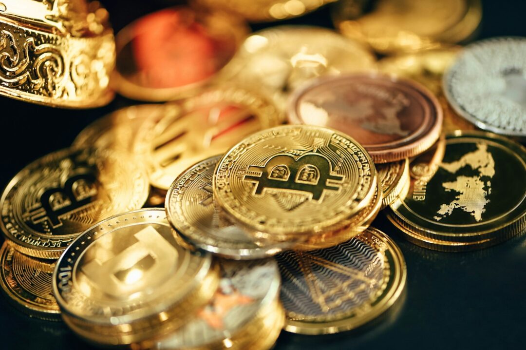 a pile of gold and silver coins sitting on top of a table