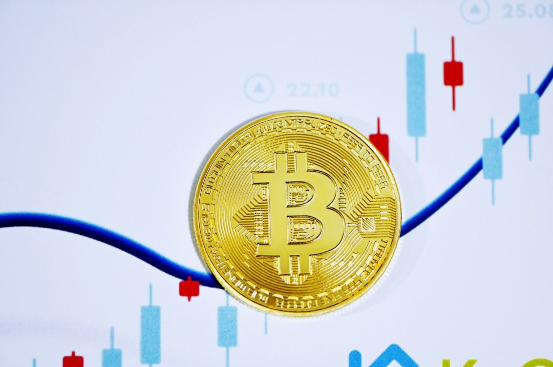 a bitcoin sitting on top of a chart