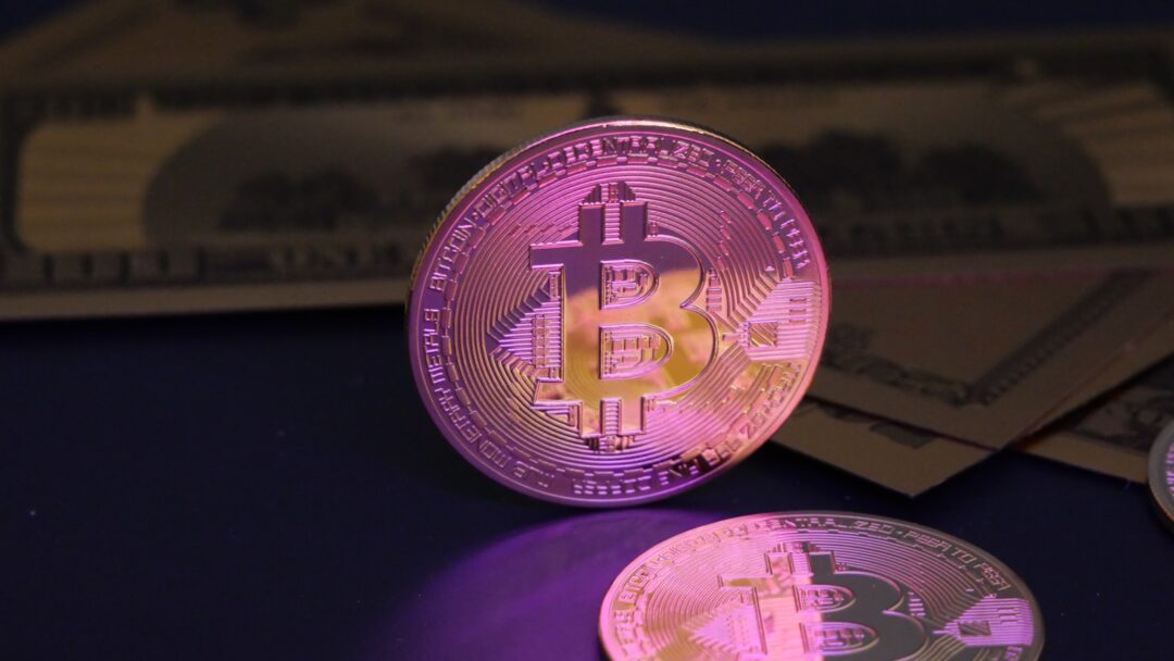 Bitcoin coin and us dollar bills