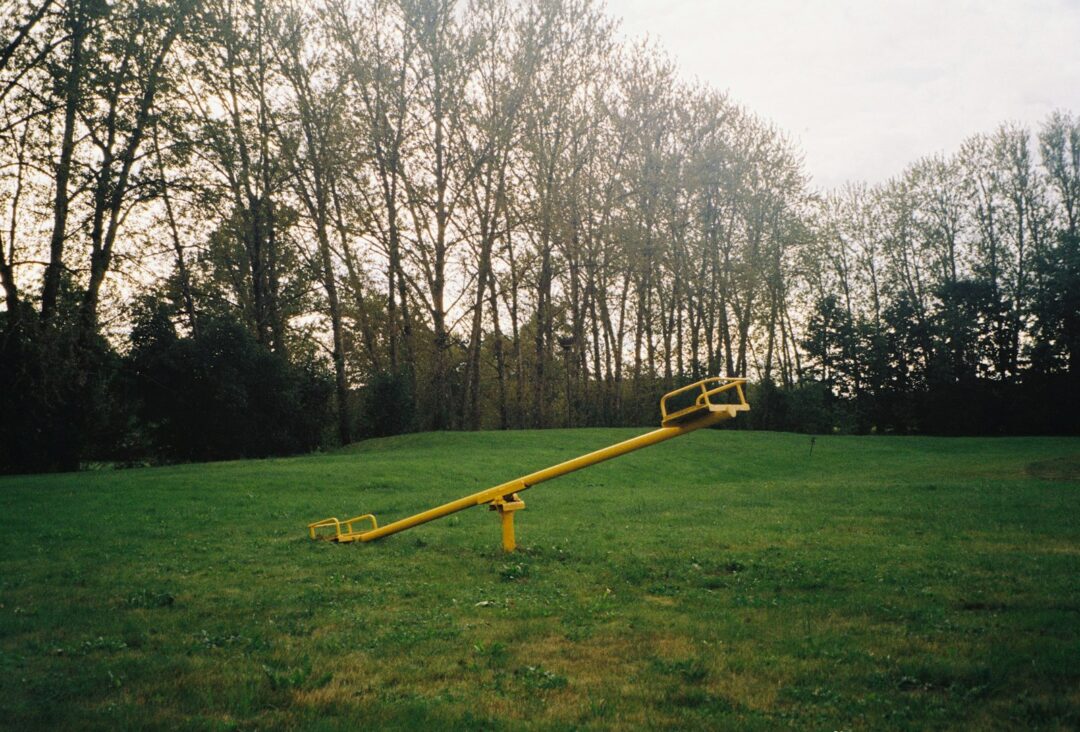 a yellow object in a grassy area